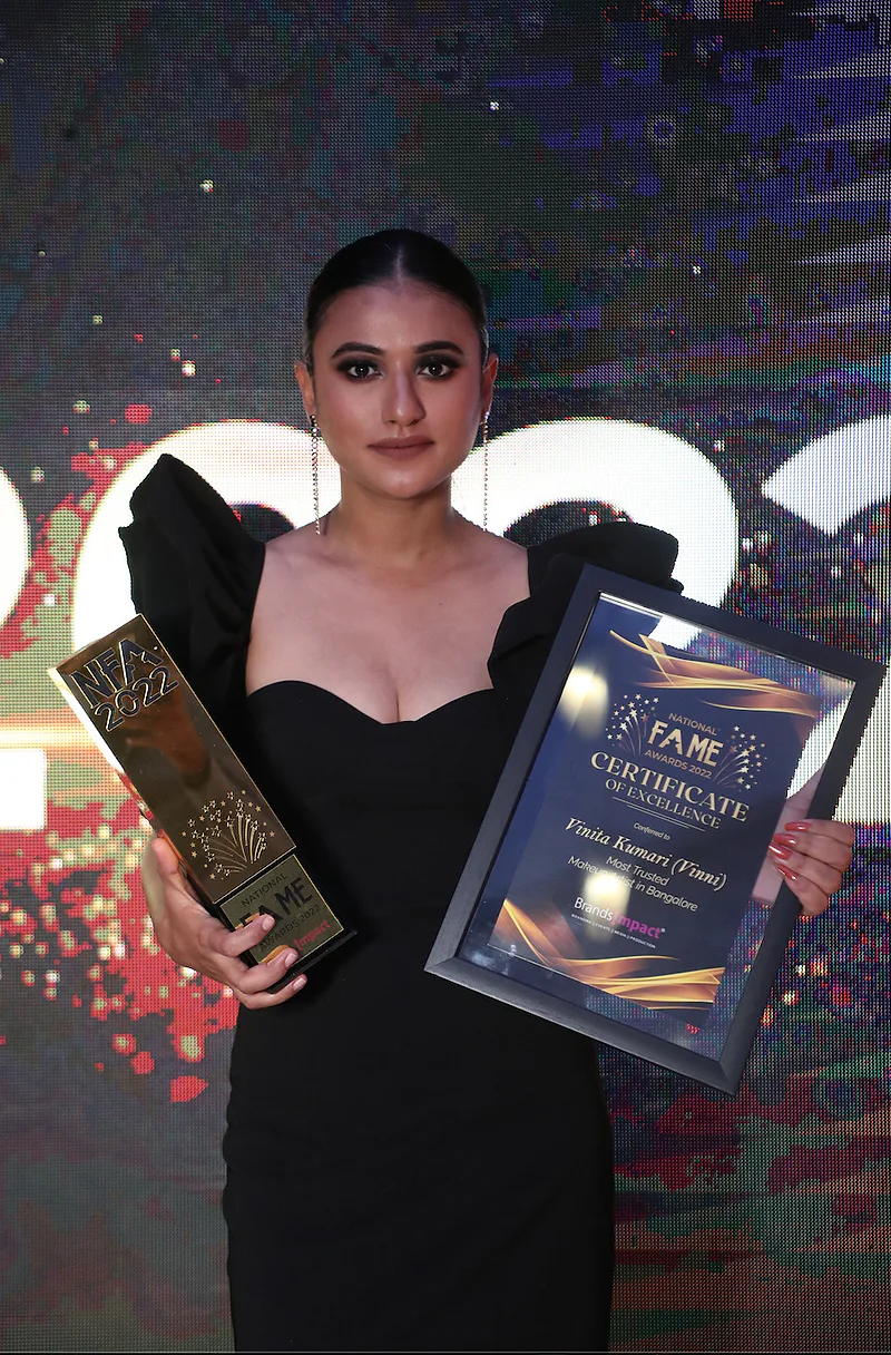 Person holding a Fame excellence certificate and trophy.
