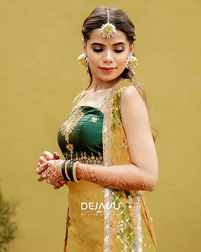 Bangalore bride with floral hair accessories and bridal makeup featuring a dewy finish.