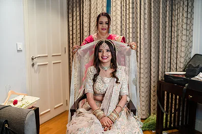 Bangalore bride in pastel lehenga with bridal makeup and glossy lip.