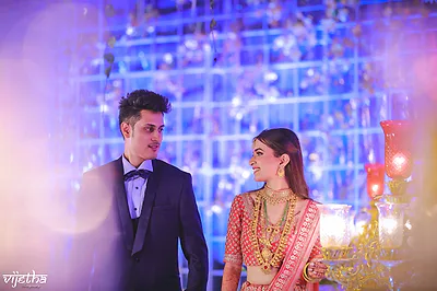Bangalore bride in red lehenga with bridal makeup and luminous highlight.