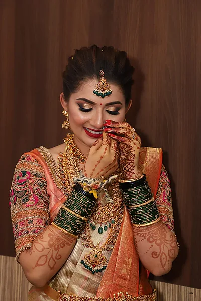 Bangalore bride with bridal makeup, radiant temple jewelry, and kohl eyes.