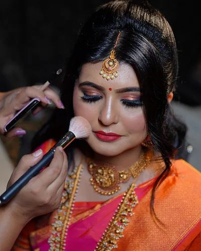 Red Radiant Temple Jewelry Bridal Portrait - Dejavu Makeup Studio Bangalore bride with bridal makeup featuring kohl eyes and a red lip.